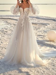 a woman in a wedding dress on the beach