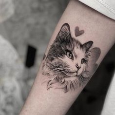 a black and white photo of a cat with hearts on it's head tattoo