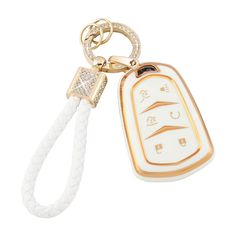 a white and gold keychain with an arabic writing on the front, and a diamond - encrusted tag attached to it