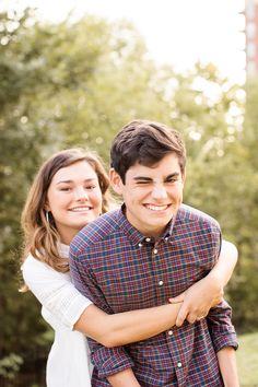 a young man and woman hugging each other