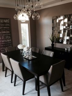 a dining room table with chairs and a chandelier