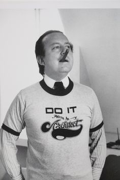 a man wearing a shirt and tie with the word do it written on his chest