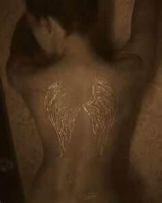 the back of a woman with angel wings painted on her body and behind her head