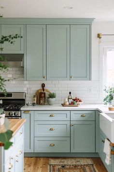 a kitchen with light blue cabinets and white counter tops is pictured in this image from the front view