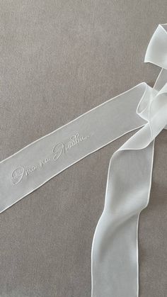 a white ribbon with the words one in another on it