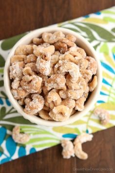 a white bowl filled with cereal on top of a table