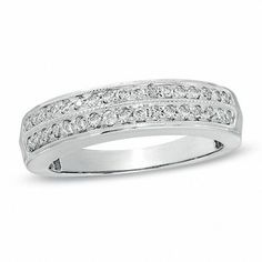 a white gold wedding band with round cut diamonds on the top and bottom, set in 18k white gold