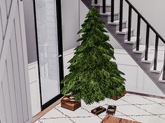 a small christmas tree sitting on top of a white rug next to a stair case