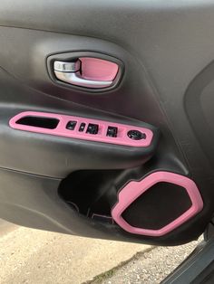 the interior of a car with pink trims and black door handle covers on it