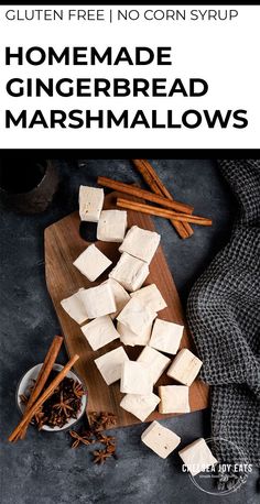 homemade gingerbread marshmallows on a cutting board with cinnamon sticks and spices