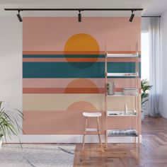 an orange, blue and pink wall mural in a living room with wooden flooring