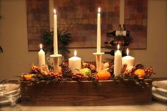 a group of candles sitting on top of a wooden table