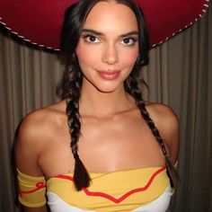 a woman with braids wearing a red hat