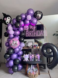 a purple and black balloon arch with the words it's my birthday