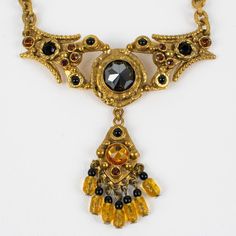 This is part of Chairish’s Costume Jewelry assortment.  Stunning Henry Perichon (aka Henry), Medieval revival gilded bronze pendant necklace. The bronze metal pendant with antique Middle-Age design influences is ornated with faceted French black jet glass cabochons and compliments with orange topaz and yellow citrine crystal rhinestones. Heavy gilded bronze worked chain. Engraved "Henry Paris" at the back of the pendant. Lobster closing clasp. Good condition, with wear on gilded bronze due to no Medieval Revival, Black Jet, French Jewelry, Bronze Necklace, Bronze Pendant, Bronze Metal, Yellow Citrine, Citrine Crystal, Accessories Jewelry Necklace