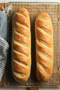 two loaves of bread sitting on top of a cooling rack