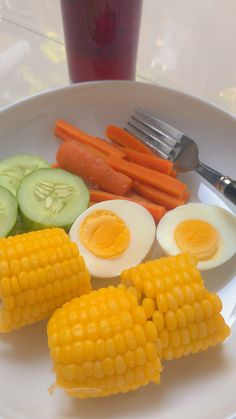 corn, carrots, and boiled egg on a plate