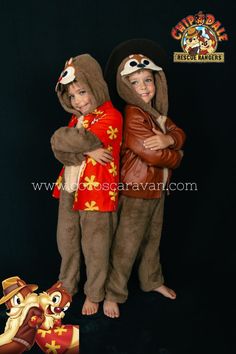 two children dressed in costumes standing next to each other with their arms around each other