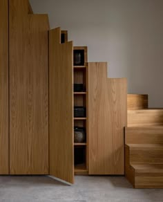 an open bookcase next to some stairs