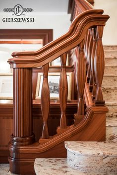 a wooden staircase with marble steps and handrails