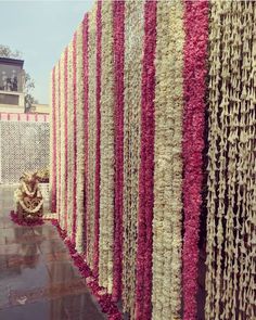 the wall is decorated with flowers and garlands