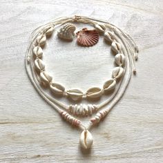 Necklaces are made of natural cowrie shells (16 - 20 mm, single shell 20 - 24 mm), milky white or alabaster rainbow and pearl white original Czech glass beads (2.9 / 4.1 mm Rocailles Preciosa), shell 'puka' beads (5-10 mm) and waxed polyester cord (original Linhasita 1 mm).  They are robust and fully waterproof.  The length is adjustable and should fit all neck sizes (minimum length is 32 cm =12,6 inches and maximum 66 cm = 26 inches).  If you have any questions/wishes, please don't hesitate to Cheap Shell Beaded Necklaces With Round Beads, Cheap Bohemian Shell Beaded Necklaces, White Shell-shaped Shell Jewelry, Adjustable White Shell Jewelry, White Cowrie Shell Jewelry, White Shell Jewelry With Ocean-inspired Style, Natural Cowrie Shell Jewelry For Gift, Natural Cowrie Shell Jewelry As Gift, Natural Color Cowrie Shell Jewelry Gift