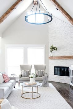 a living room with two couches and a coffee table in front of a fireplace