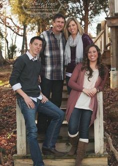 a group of people standing on steps in the woods