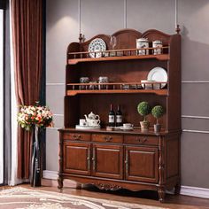 a wooden china cabinet in a living room