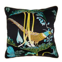 a black pillow with yellow and blue birds on it