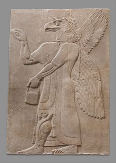 an ancient egyptian relief depicting a winged bird carrying a bucket and a fish in it's beak