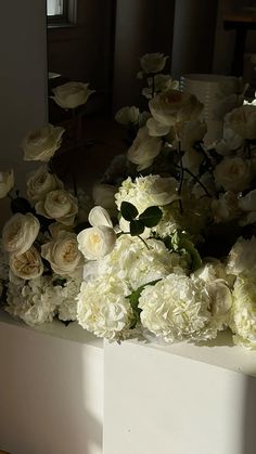 white flowers in a vase on a table