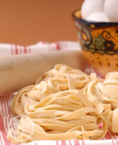 some pasta is sitting on a red and white towel