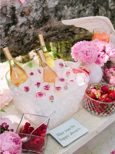 pink flowers and wine bottles on a table