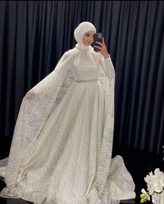 a mannequin dressed in white is taking a selfie with her cell phone