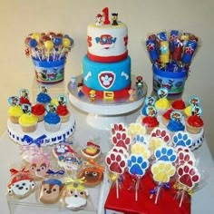 a table topped with lots of cupcakes and cakes