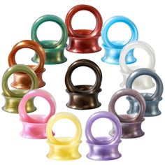 an assortment of colored plastic rings on a white background