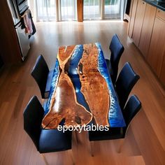 a dining room table made out of wood and blue glass in the center with chairs around it