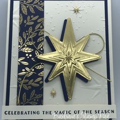 a christmas card with a gold and black star ornament on it, along with the words celebrating the magic of the season