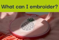 an embroidered pineapple on a pink shirt with the words what can i embroider?