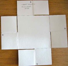 several pieces of white paper laid out on a table