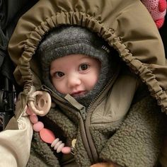 a baby in a stroller with a stuffed animal