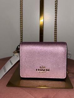 .New Coach .NWT, Excellent condition .Gold Chain Shoulder Strap .Card slots .The main enclosure is magnetic. Coach Mini Wallet, Wallet With Chain, Sling Bags, Coach Wallet, Mini Wallet, Wallet Chain, Mini Crossbody, Cross Body Handbags, Gold Chain