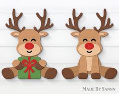 two wooden reindeers with red nose and antlers holding a present