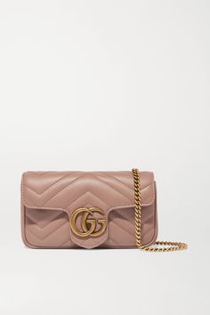 One look at the interlocking logo and quilted finish on this bag, and you know it belongs to Gucci's 'GG Marmont' family. Scaled down to a 'Super Mini' size, it's crafted from buttery leather in a pretty dusty-pink hue and has just enough room for the essentials. Carry it cross-body, or with the chain strap doubled up over your shoulder. Marmont Super Mini, Gucci Marmont Bag, Best Designer Bags, Gucci Marmont, Gucci Gg Marmont, Leather Duffle, Gg Marmont, Classic Bags, Designer Shoulder Bags