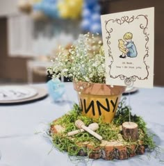 there is a small potted plant on top of a table with a note in it