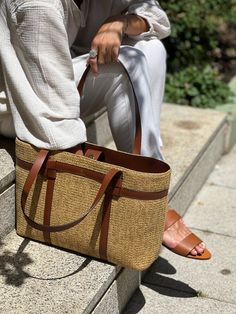 Handbag Jute tote with leather details, the best accessory for this summer.   Leather shoulder strap.  Inside pocket.   Organic and metal-free design.  Dimensions: Length 46cm, height 26cm, 31cm with handles, width 12cm.  Magnet closure.  Bag with excellent finishes that will allow you to carry everything you need on your summer days or even, if you need it, a computer or iPad. Its long handles allow you to hang it on your shoulder so you can keep your hands free. Its lightness and design will Elegant Straw Tote Bag For On-the-go, Casual Straw Bag With Detachable Handle For Travel, Brown Straw Shoulder Bag For On-the-go, Chic Travel Bag With Adjustable Strap And Double Handle, Casual Everyday Straw Bag With Detachable Handle, Large Capacity Shoulder Bag With Long Handle For Travel, Travel Shoulder Bag With Large Capacity And Long Handle, On-the-go Satchel With Leather Handles, Elegant Everyday Leather Straw Bag