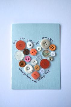 a heart made out of buttons on a blue background