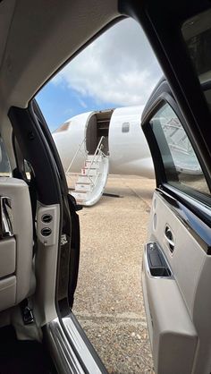 an airplane is parked on the tarmac with it's door open and another plane in the background