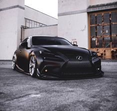 a black car parked in front of a building